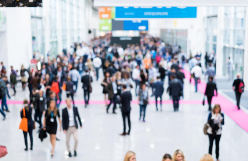 Widok z góry na tętniące życiem targi w nowoczesnym wnętrzu.